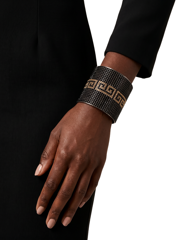 The Black and Gold cuff bracelet worn on the wrist